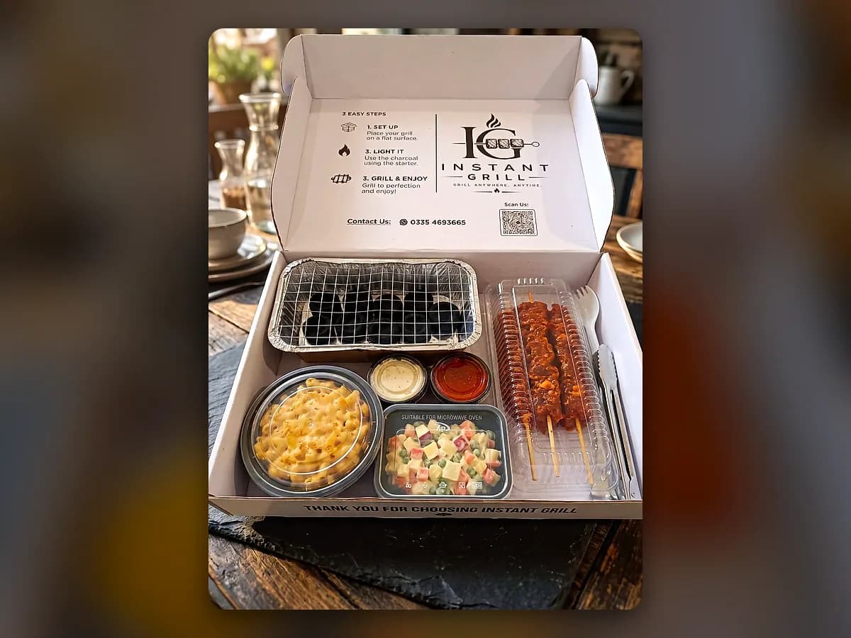 An open Instant Grill box: grill, coal, skewers and sides
